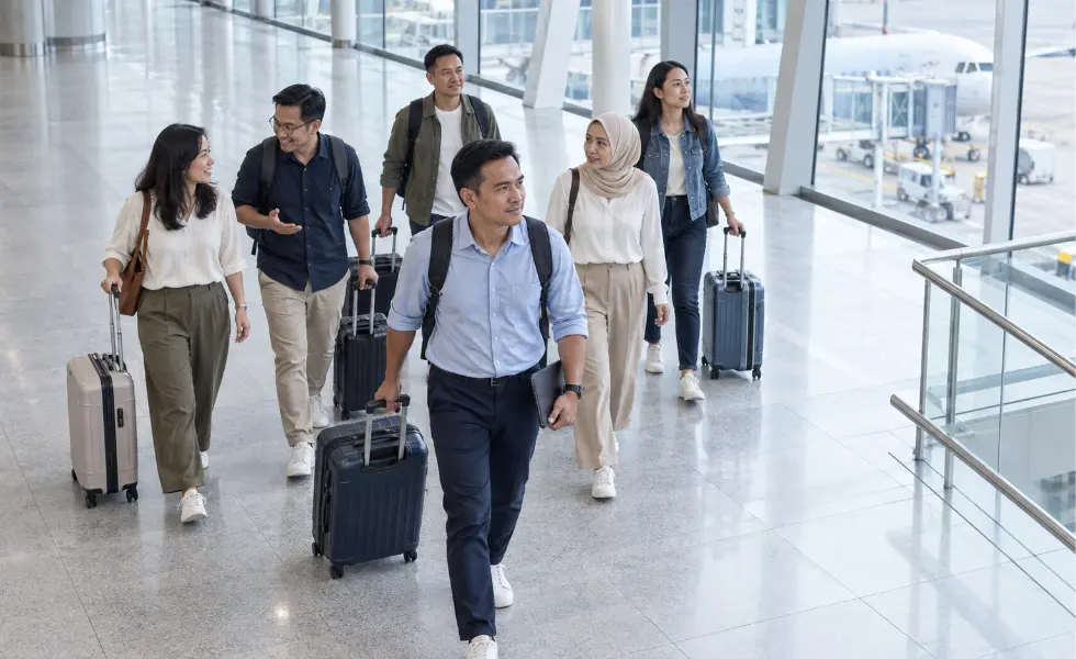 A Malaysian group departure moving calmly through an airport terminal